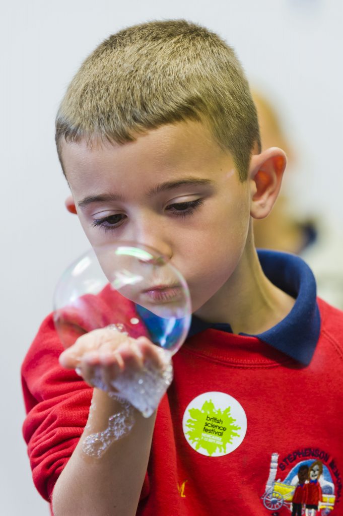 A boy blowing a bubble at the British Science Festival 2013
