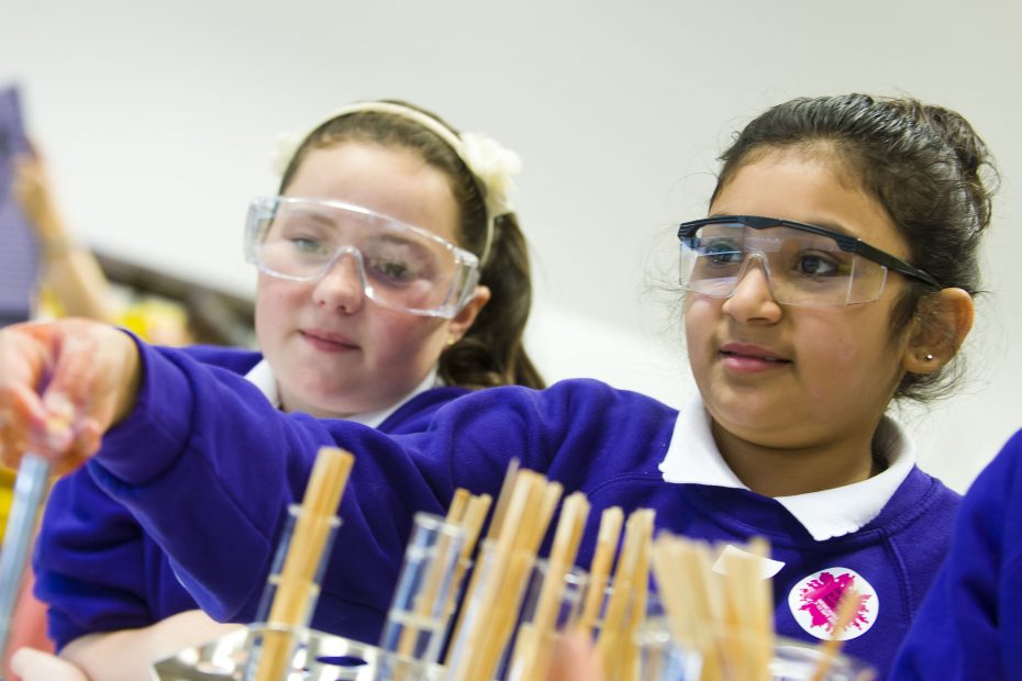Two girls doing flame tests at the British Science Festival 2013
